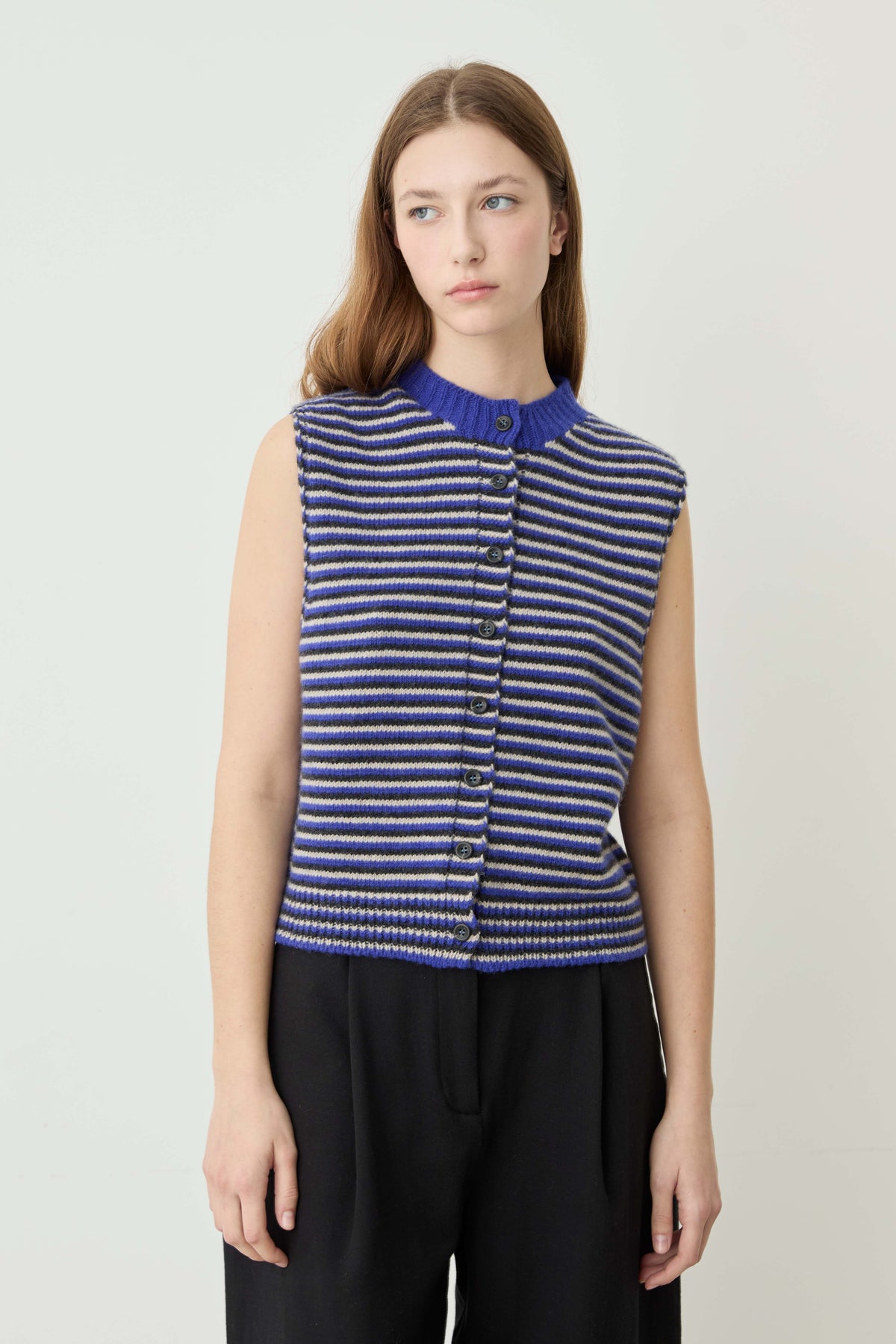 Woman wearing a Blue striped sweater vest - 1