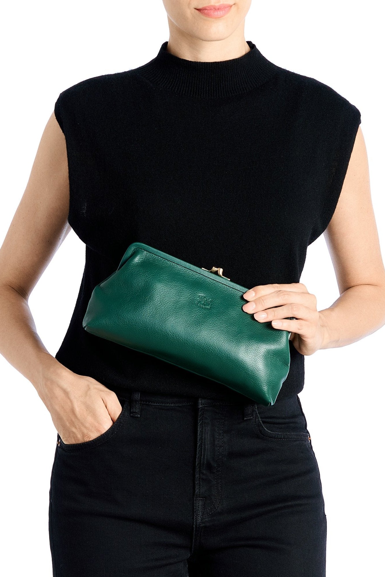 Person holding a green clutch bag against a white background