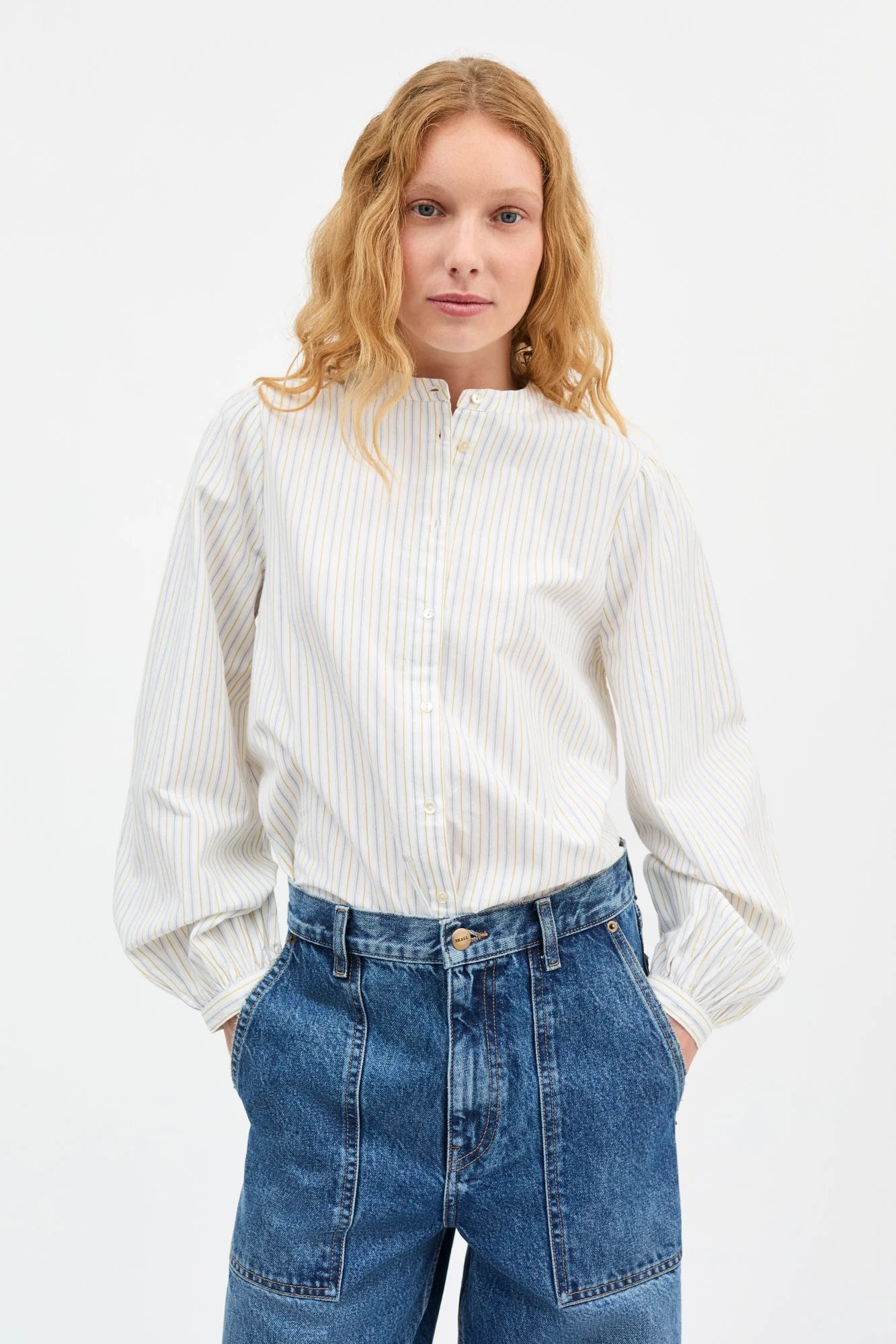 woman wearing a stripe white collarless button down shirt from Skall
