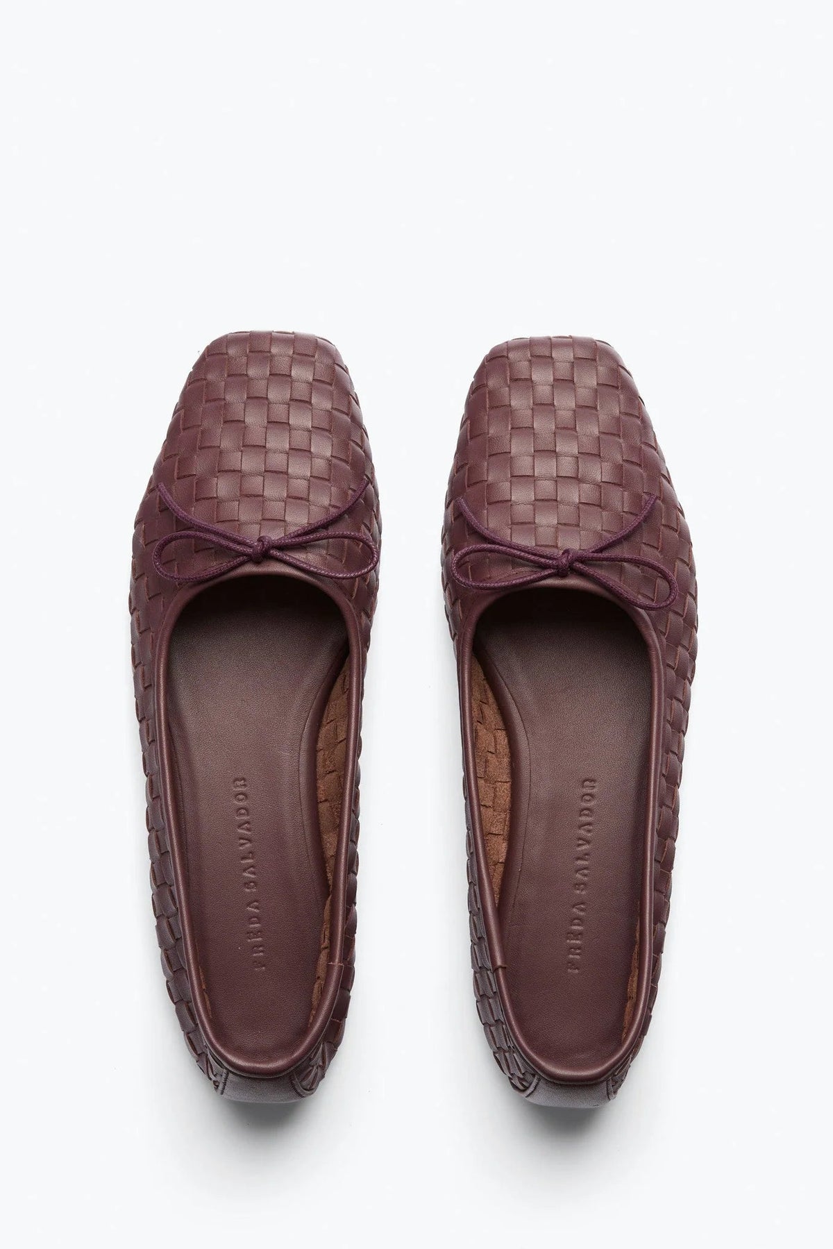 A pair of women's woven leather loafers in a deep plum-brown color, shown from a top-down view on a clean white background. - 1