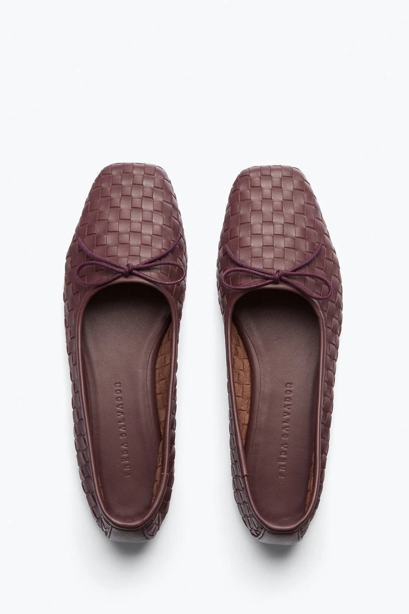 A pair of women's woven leather loafers in a deep plum-brown color, shown from a top-down view on a clean white background.