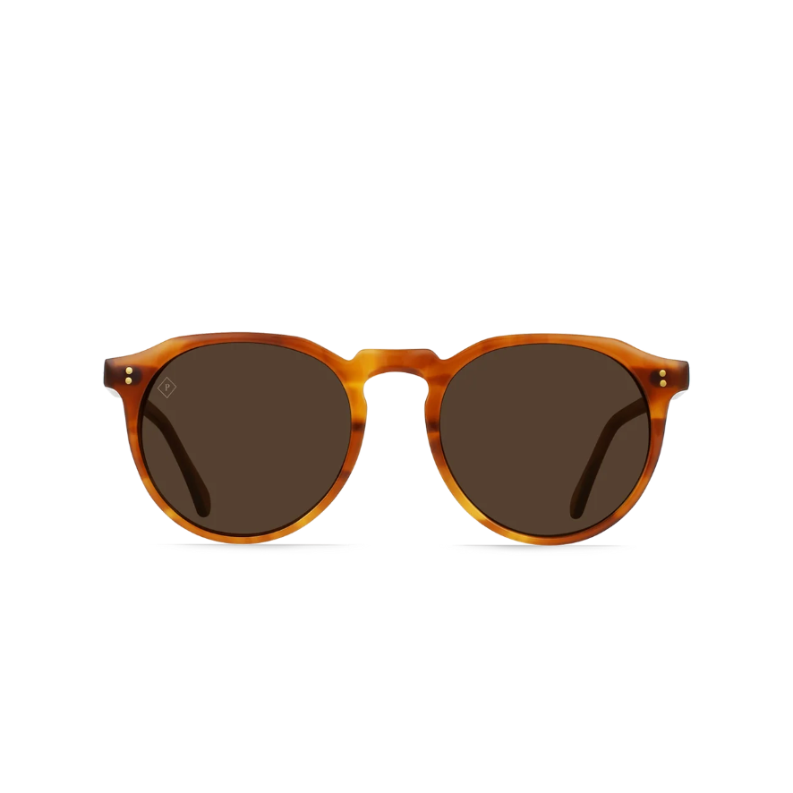 Round sunglasses with a translucent amber-brown tortoiseshell frame and dark brown lenses, shown against a solid white background.